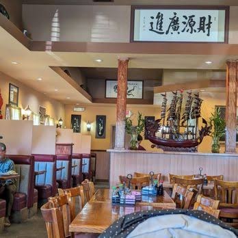 Dragon Treasure's dining room, with wood booths and the dragon boat display