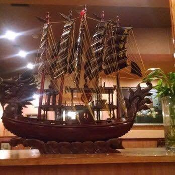 Hand-carved dragon boat model displayed inside Dragon Treasure's dining room